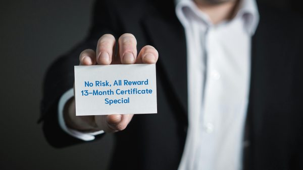 Hand holding a card that reads: No Risk, All Reward 13-Month Certificate Special