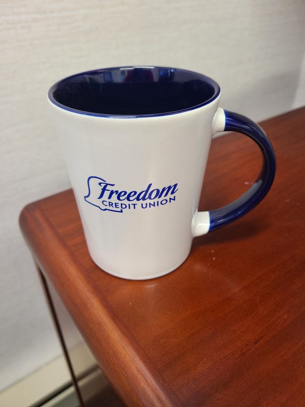 Freedom Credit Union mug on table