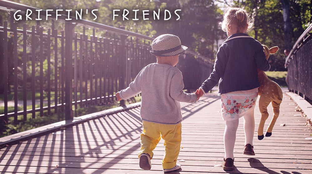 two young children walking on bridge holding hands